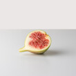 Ripe cutted fig on gray table. Food concept.