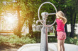 Water Well in Modern Water Playground. Little Child pumps Hand Pump in Nature in Green City. Educational Game for Children. 