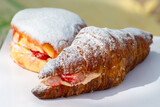 Fototapeta Kuchnia - Dutch cuisine, fresh baked strawberry cake and croissant with cream and fresh fruits