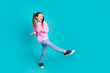 Full length photo of lovely little girl dancing have fun dressed stylish pink garment isolated on aquamarine color background