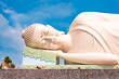 Lying Buddha statue in Vietnam with blue sky