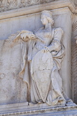 Wall Mural - Sculpted Standing Woman Wearing a Crown and Holding a Shield and a Palm at the Vittoriano in Rome, Italy