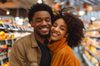© Mikhail - Portrait of a happy afro-american couple in supermarket. Shallow depth of field