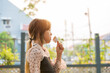 Young asian girl eating an ice cream in outdoor with sunny day.