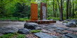 Modern water feature with artistic rust sculpture in forest