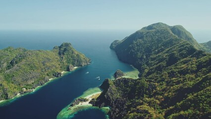 Wall Mural - Green mountain islands at sea bay coast aerial view. Ocean islets seascape of tropical forest at hilly islands of El Nido, Philippines. Nature scenery of blue ocean water at summer sunny day