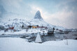 Snowy Lofoten Islands with fishing village and mountain during winter at Norway