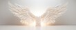 Softly lit mockup of angel wings, showcased against a seamless white backdrop to highlight delicate details and purity