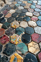 Poster - A mosaic floor where interlocking hexagons slowly transition into chaotic, broken tessellations, rep