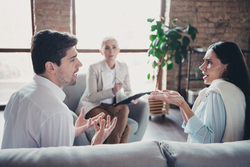 Canvas Print - Photo of young couple angry quarrel psychotherapist office mature woman family counseling have conversation therapy session