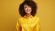 © Anastasiia - Radiant Woman with Curly Hair Smiling Against Yellow Background