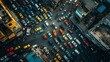 Overhead view of a bustling city street teeming with cars in a gridlock as evening falls