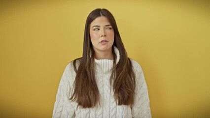 Sticker - Panic-stricken young hispanic woman simulates suicide, forming gun with fingers to head, standing over yellow isolated background.