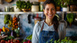 © chekart - A woman is smiling in front of a kitchen counter with a variety of vegetables and fruits. She is wearing a blue apron and she is a chef or a cook