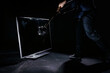 Man holding a sledgehammer, hitting and smashing a plasma television, isolated on a black background, slow motion locked down shot. People and technology concepts.
