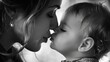 A mother tenderly kissing her baby's forehead in a moment of pure love