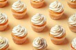 Delicious cupcakes with white frosting on a yellow surface. Perfect for bakery or dessert concepts