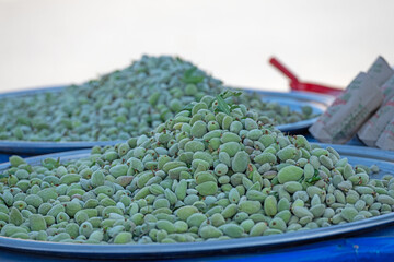 Wall Mural - Green almonds from a street vendor stall.