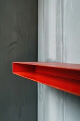 Poster - Detailed shot of a red shelf mounted on a wall, suitable for interior design concepts