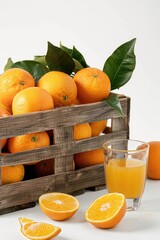 Poster - Fresh oranges in a crate next to a glass of orange juice. Perfect for food and drink concepts