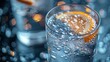   A tight shot of a glass filled with water Orange slice hovering at rim's edge Backdrop softly blurred