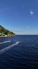 Wall Mural - A visual symphony of sea, sky, mountains, and traditional boat races, Journey through gorontalo city, indonesia.