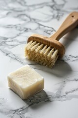 Poster - A wooden brush and soap on a marble surface, suitable for bathroom or spa concept