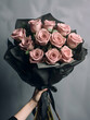Pink flowers, wrapped in black paper, cropped photo, bouquet close up