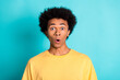 Portrait of speechless man with afro hairstyle wear oversize t-shirt staring at awesome discount isolated on teal color background