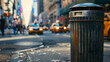 Trash can on a busy city street with blurred background
