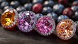   A row of differently colored diamonds lies atop a black surface, surrounded by blueberries in the background