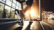 Legs running on treadmill, white shoes blur, gym sunny background. Sunlit gym scene with legs in motion, running on a treadmill.