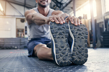 Poster - Fitness, feet and man with stretching at gym for exercise, preparation and performance on floor. Health club, training and legs of male person with warm up for flexibility, workout and cardio energy