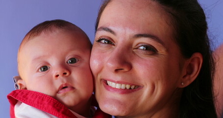 Wall Mural - Mother posing for photo with infant baby son looking to camera portrait happy and joy