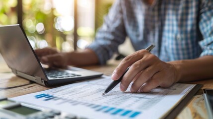 Poster - Man Analyzing Financial Documents at a Wooden Desk