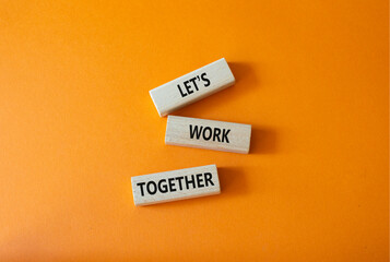 Wall Mural - Lets work together symbol. Concept words Less is More on wooden blocks. Beautiful orange background. Business and Less is More concept. Copy space.