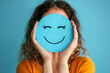 © Vectorsection - woman holding a happy blue smile face paper cut positive thinking, mental health assessment , world mental health day concept, blue background