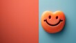 Orange smiling face toy on blue and orange background
