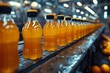 Liquid orange drink bottles on factory conveyor belt