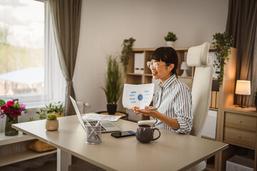 Wall Mural - Mature japanese woman hold document and have consultation via video call