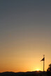 Silhouette of a flag on the background of the setting sun