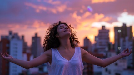 Wall Mural - Young Latin woman against a cityscape backdrop at dawn, meditating with arms outstretched, embracing the calm, styled as a soft-focus contemporary portrait.