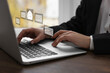© New Africa - Email. Woman using laptop at table, closeup. Letter illustrations over device
