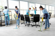 © Pixel-Shot - Team of young janitors cleaning in office
