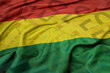 waving colorful national flag of bolivia on a euro money banknotes background. finance concept.
