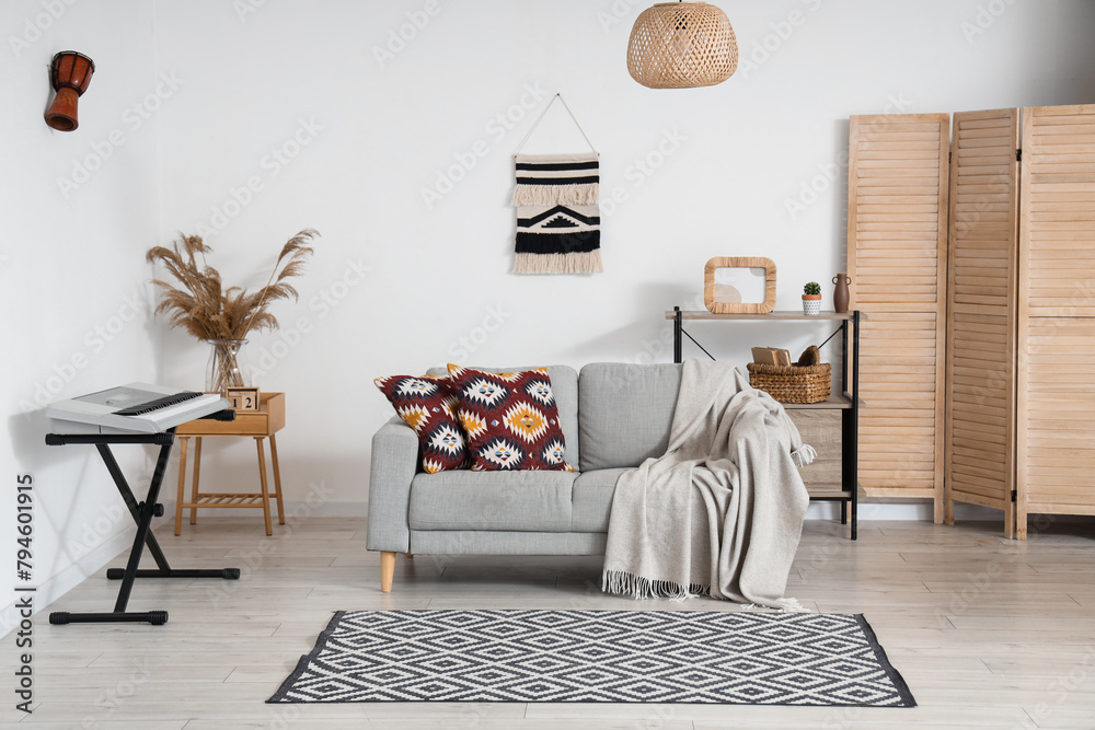 Interior of living room with sofa and synthesizer