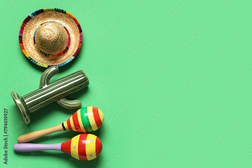 Mexican maracas with sombrero and cactus on green background. Cinco de Mayo