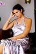 Young Caucasian Woman Sitting In Elegant Dress