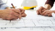 © seogi - Close-up of hands of two architectural or engineering professionals laying out and reviewing floor plan. One person is holding a pencil. Generative AI