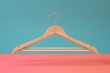 Wooden hangers toned living coral color copy space for text